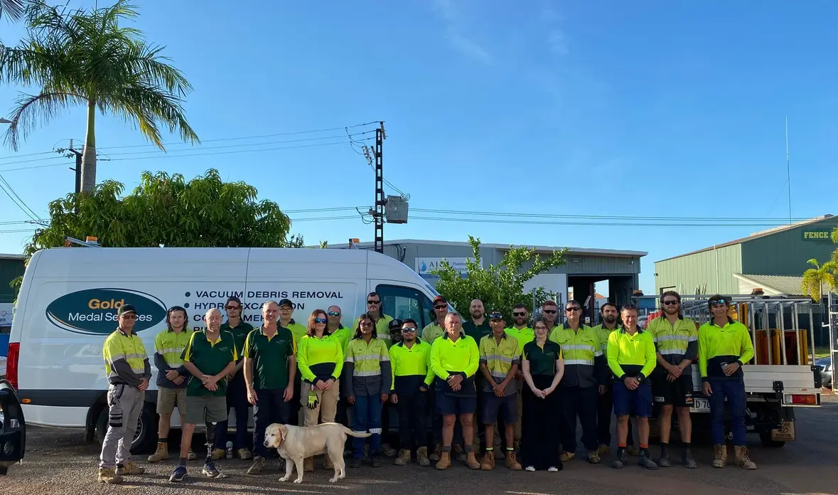 Work crew in safety uniforms beside company van