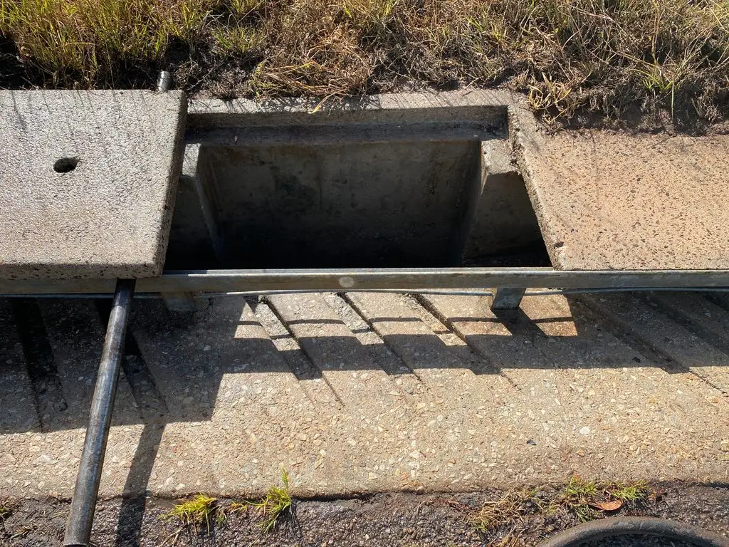 Concrete storm drain with metal railing and pipe
