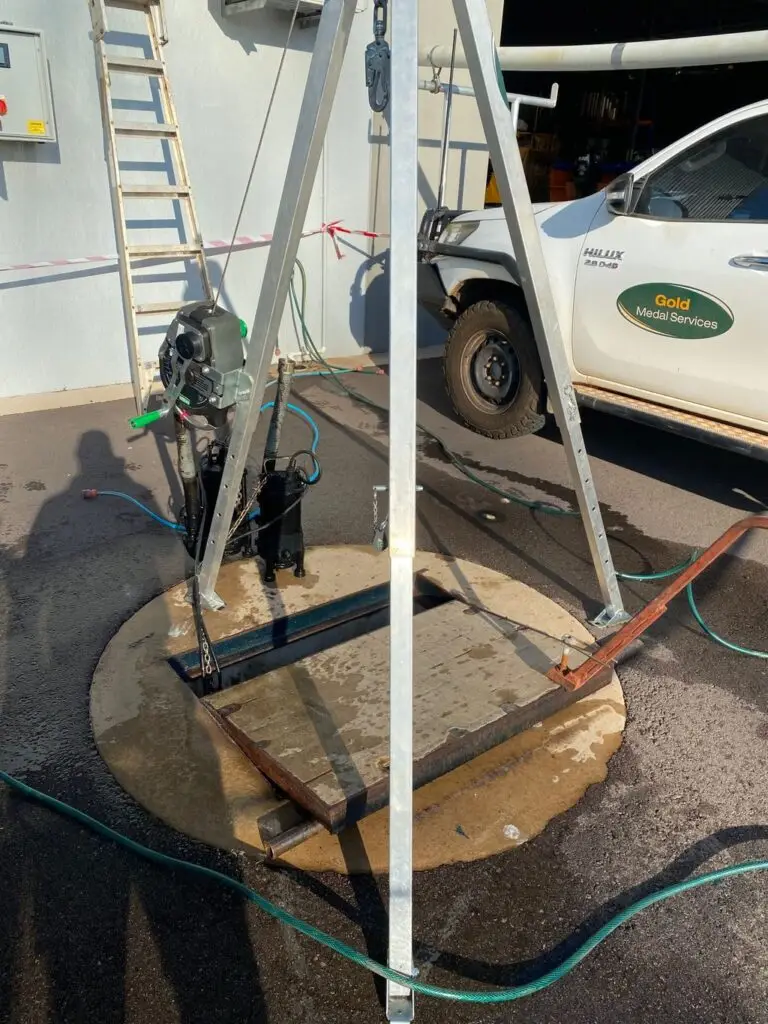 Water pump setup near service vehicle and manhole