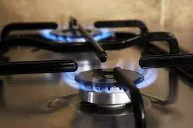 Blue gas flames burning on kitchen stove