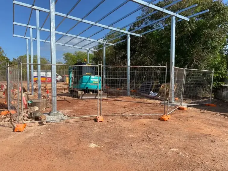 Construction site with equipment and fencing.